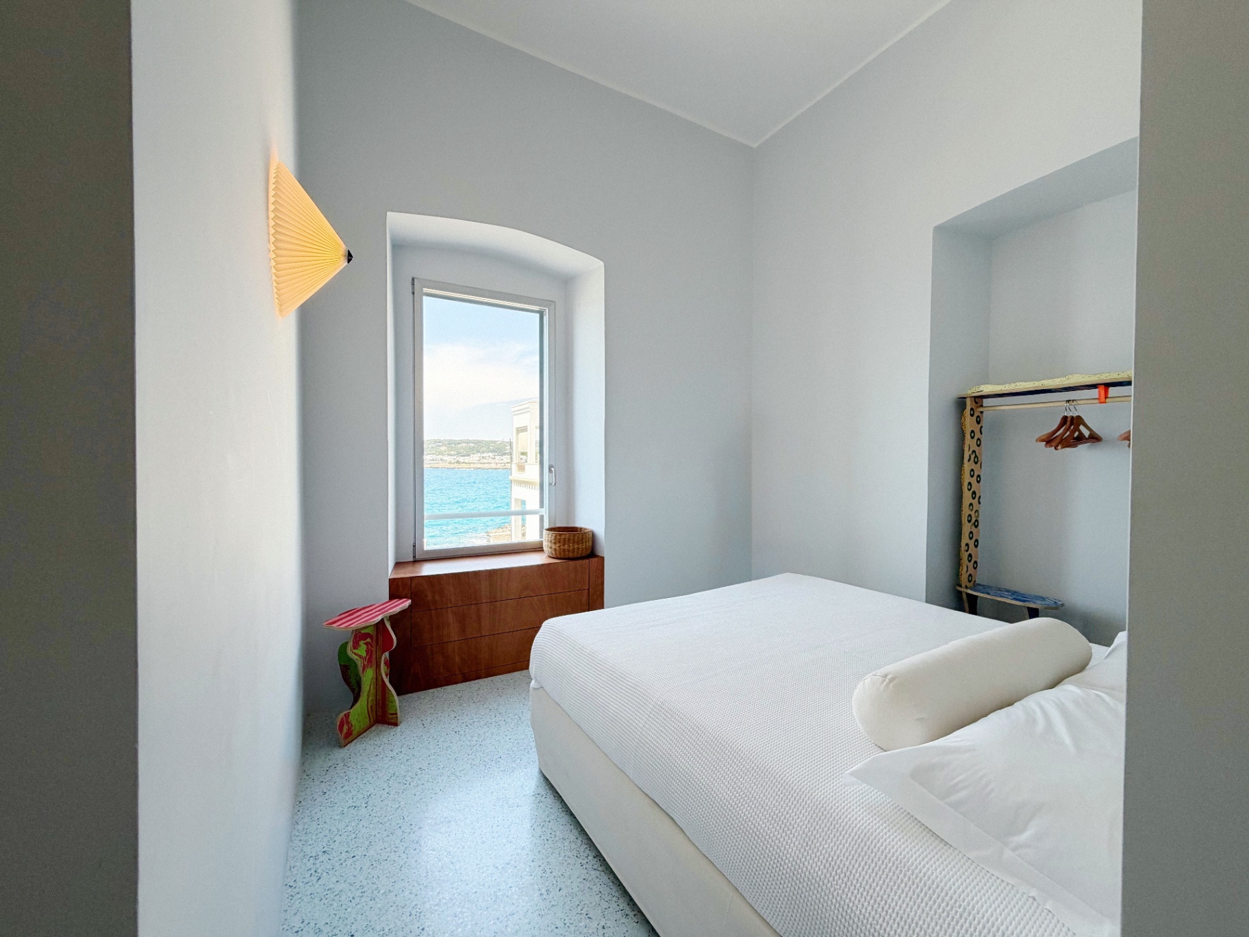 Bedroom at dusk with sea-facing window
