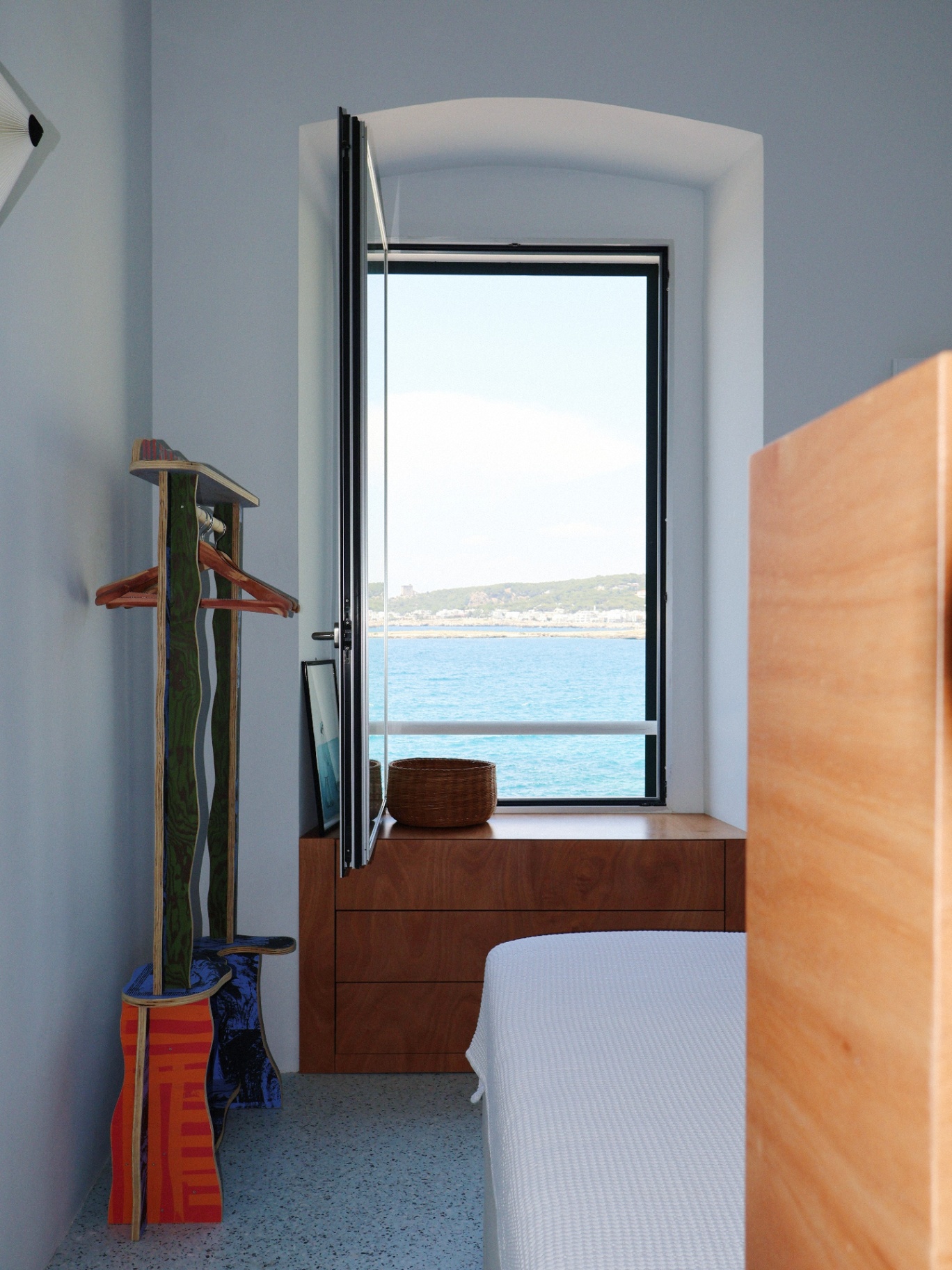 Bedroom with lime-textured cabinetry and warm headboard light